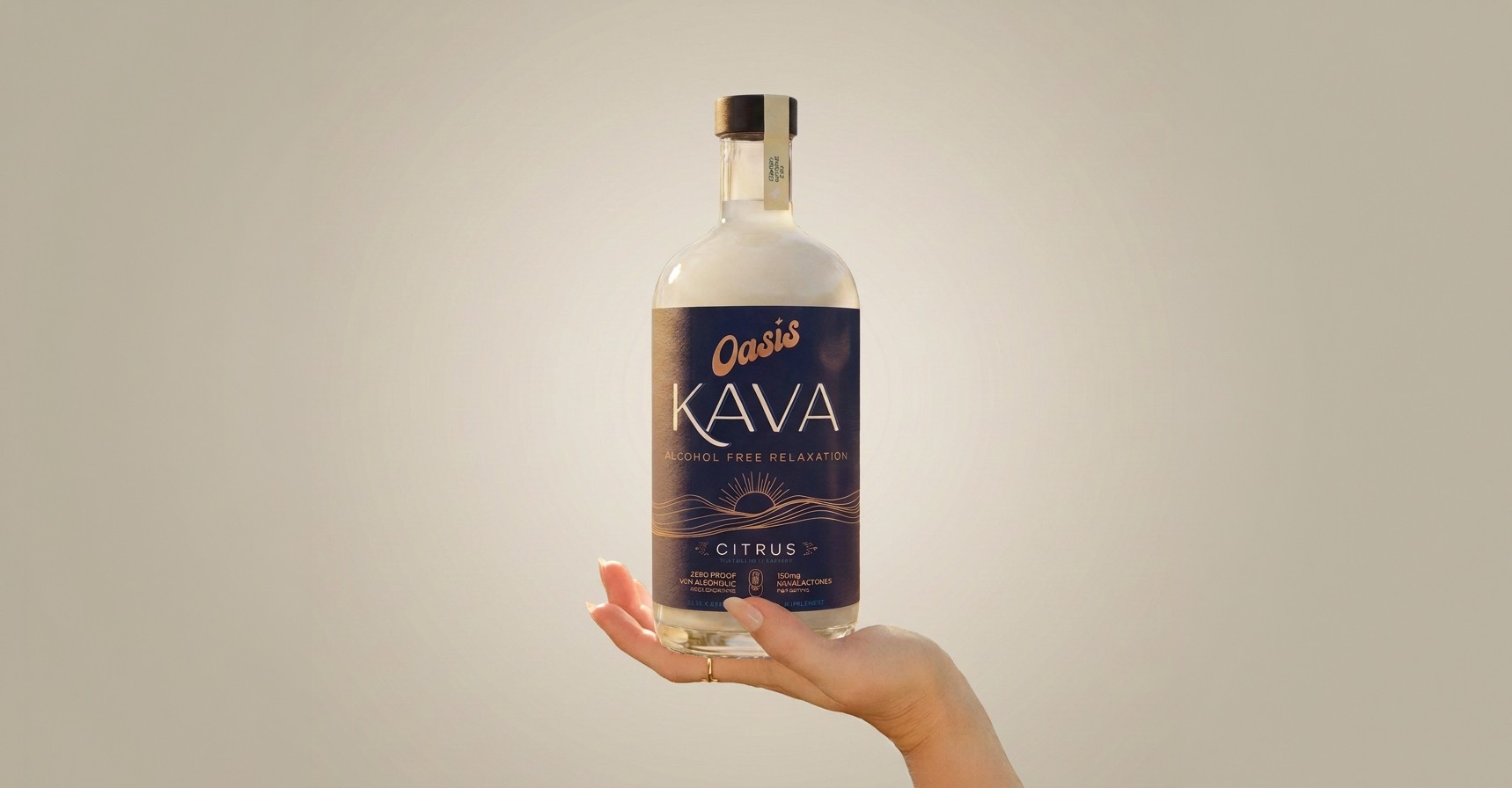 A hand holding up a bottle of Oasis Kava Spirit